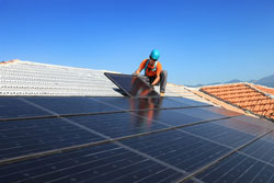 man installing a solar array